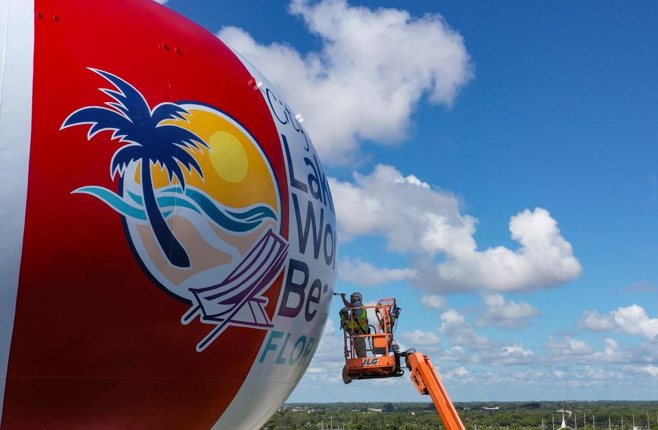 Jimmy Kelly paints the last letters on the side of the water tower in Lake Worth Beach, Florida on 2023.