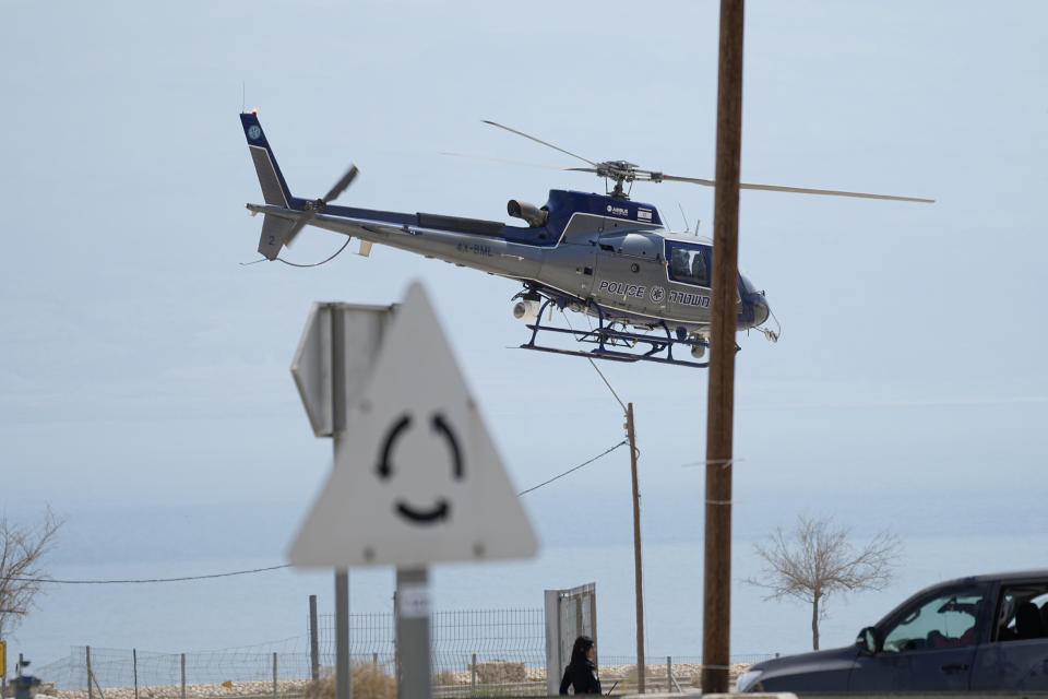 An Israeli police helicopter works at the site of a rockslide that took place in the Ein Gedi Nature Reserve, on the western shore of the Dead Sea, a popular tourist site in Israel, Thursday, Aug. 24, 2023. An avalanche of rock tumbled down a hillside near the Dead Sea, Israeli medics said, injuring several people. (AP Photo/Ohad Zwigenberg)