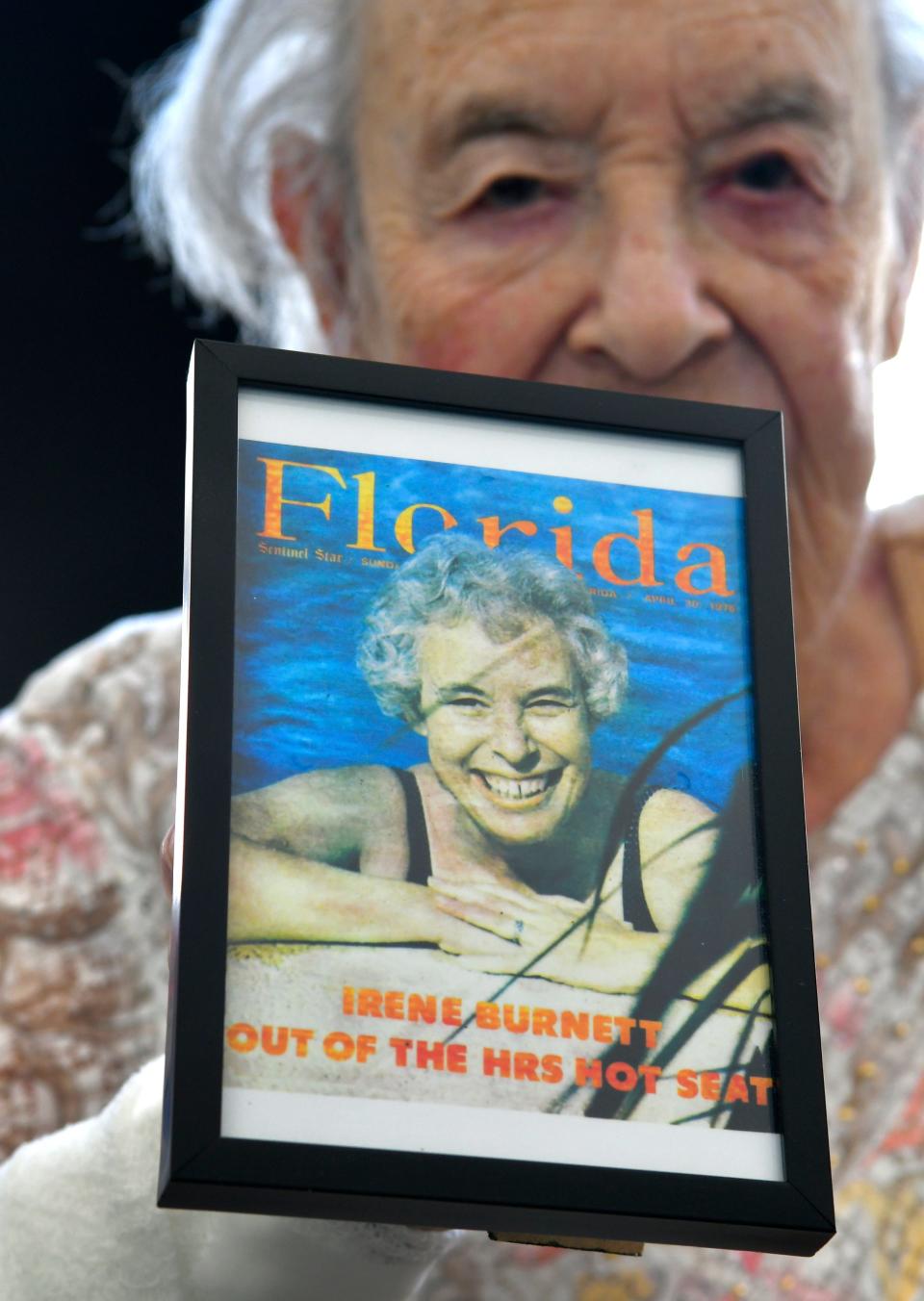 Irene Burnett is pictured at home on Merritt Island, where she lives at the edge of Sykes Creek. She is holding a small copy of an April 1978 cover story about her in Florida magazine, then a part of the Sentinel Star (now the Orlando Sentinel).