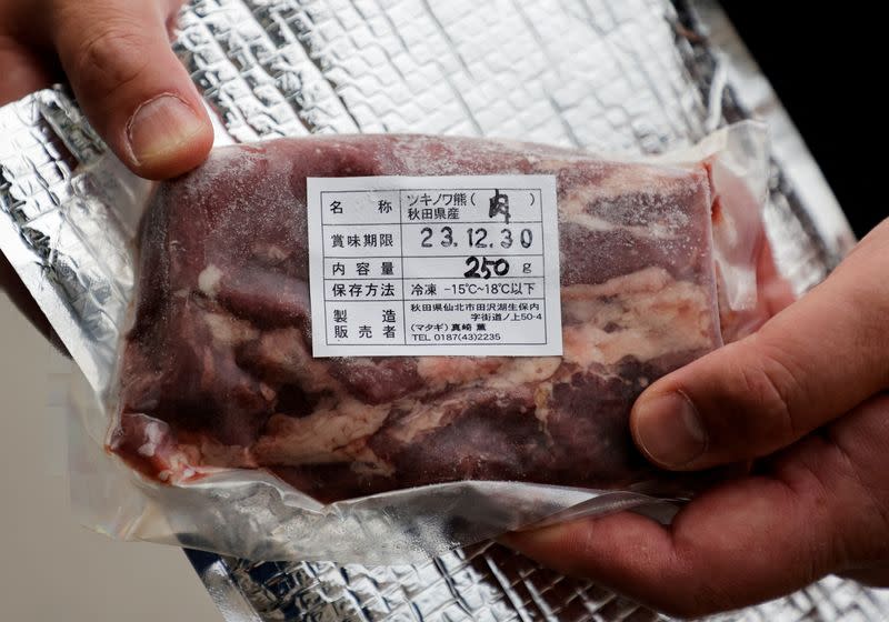 Daishi Sato, owner of Soba Noodle restaurant and the vending machine, shows a pack of Asian Black Bear meat in Semboku