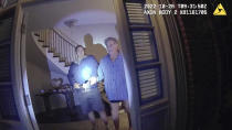 This image from video from police body-worn camera footage, released by the San Francisco Police Department, shows Paul Pelosi, right, fighting for control of a hammer with his assailant, David DePape, during a attack at Pelosi's home in San Francisco on Oct. 28, 2022. DePape wrests the tool from Pelosi and lunges toward him the hammer over his head. The blow to Pelosi occurs out of view of the video as officers rush into the house and subdue DePape. (San Francisco Police Department via AP)