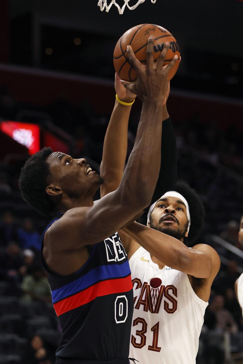 Detroit Pistons center Jalen Duren (0) is defended by Cleveland Cavaliers center Jarrett Allen (31) while going to the basket during the first half of an NBA basketball game Saturday, Dec. 2, 2023, in Detroit. (AP Photo/Duane Burleson)