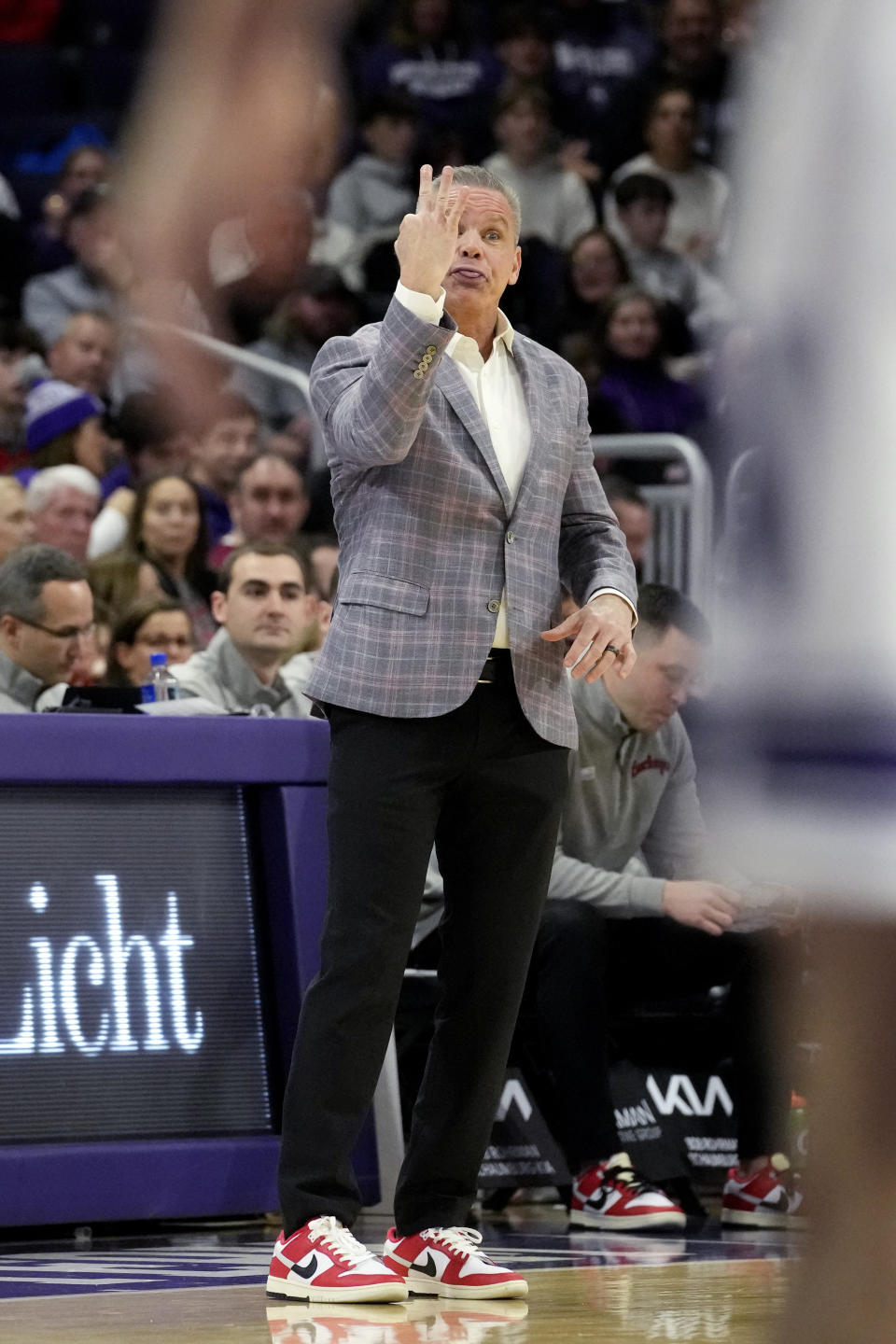 Ohio State head coach Chris Holtmann signals to his team during the first half of an NCAA college basketball game against Northwestern in Evanston, Ill., Saturday, Jan. 27, 2024. (AP Photo/Nam Y. Huh)
