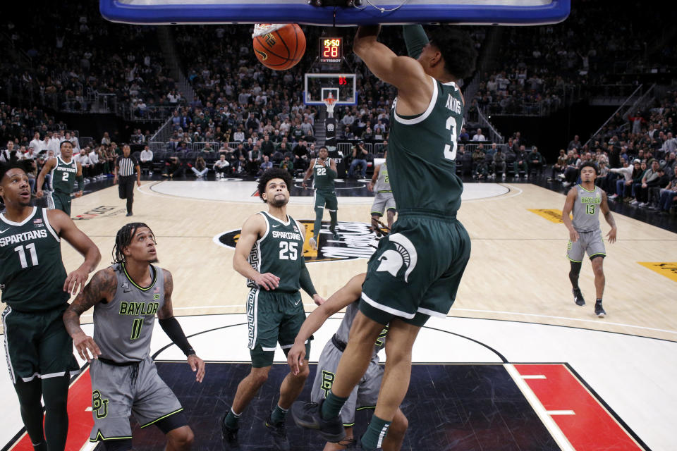 Michigan State guard Jaden Akins (3) dunks over Baylor forward Jalen Bridges (11) as Michigan State guard A.J. Hoggard, left, and Michigan State forward Malik Hall (25) watch during the second half of an NCAA college basketball game, Saturday, Dec. 16, 2023, in Detroit. Michigan State won 88-64. (AP Photo/Al Goldis)