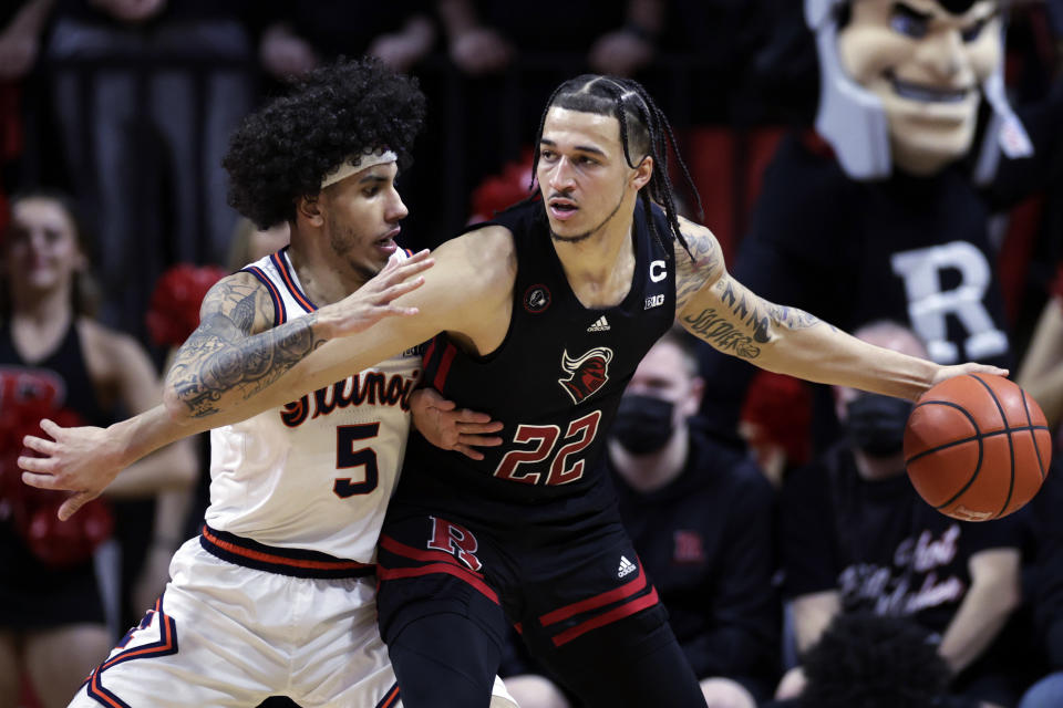 Rutgers guard Caleb McConnell (22) drives against Illinois guard Andre Curbelo (5) during the first half of an NCAA college basketball game Wednesday, Feb. 16, 2022, in Piscataway, N.J. (AP Photo/Adam Hunger)