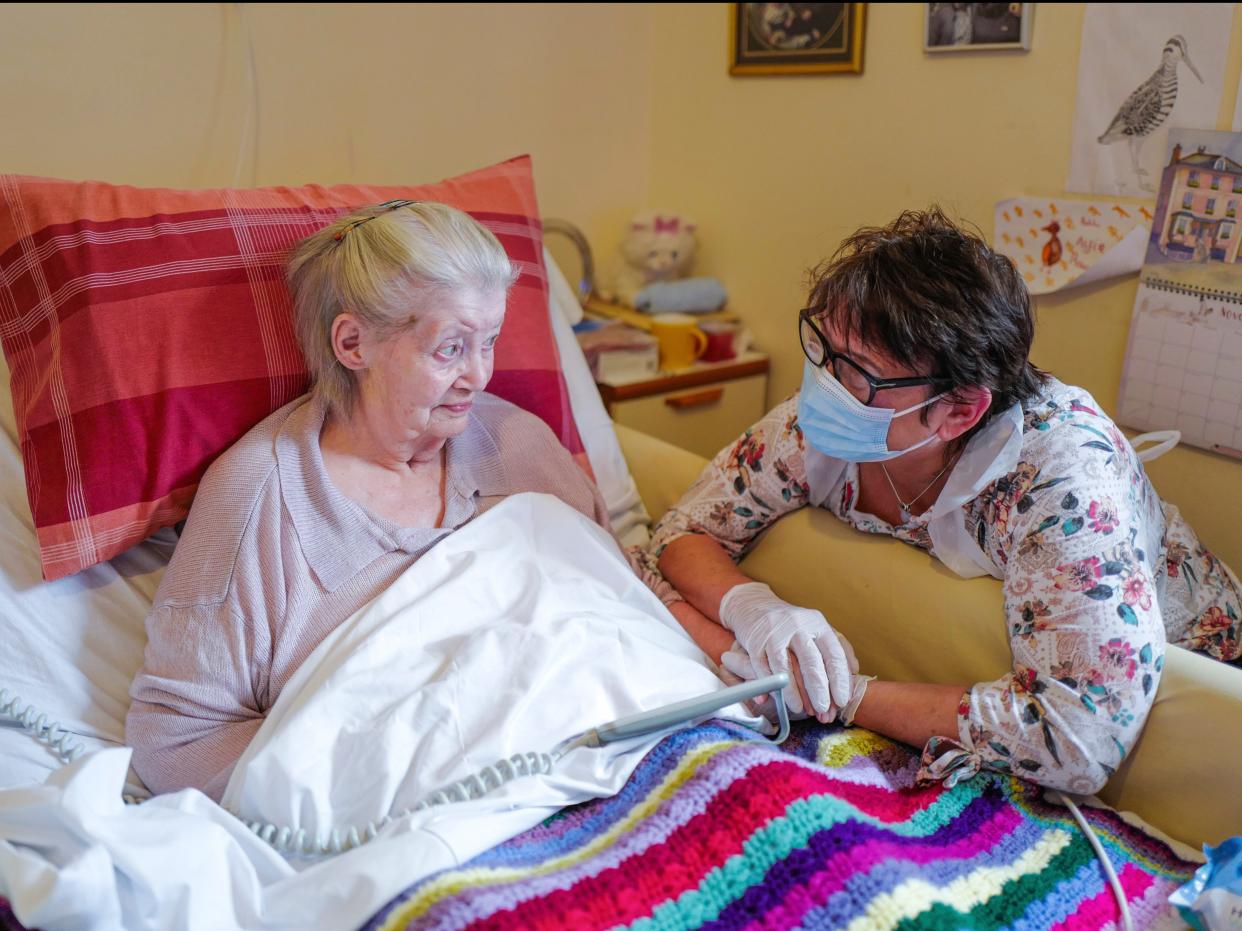 Care home resident Dot Hendy holds her daughter Louise’s hand last week for the first time since March (Hugh Hastings/Getty Images)