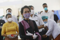 Myanmar leader Aung San Suu Kyi inspects and watches the vaccination processes to health workers at a hospital Wednesday, Jan. 27, 2021, in Naypyitaw, Myanmar. Health workers in Myanmar on Wednesday became the country's first people to get vaccinated against COVID-19, just five days after the first vaccine supply was delivered from India. (AP Photo/Aung Shine Oo)