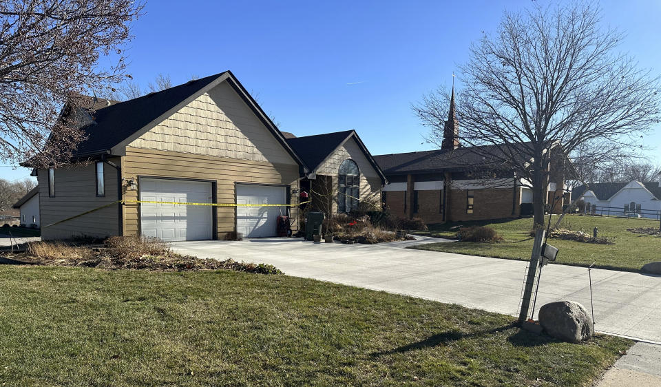 Crime scene tape surrounds the rectory at St. John the Baptist Catholic Church in Fort Calhoun, Neb., Monday, Dec. 11, 2023, one day after a priest was fatally stabbed there during a break-in. (AP Photo/Josh Funk)