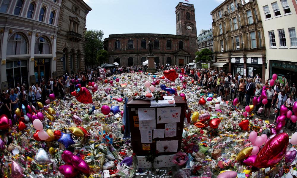People look at floral tributes for the victims of the Manchester Arena attack, in St Ann’s Square, in central Manchester