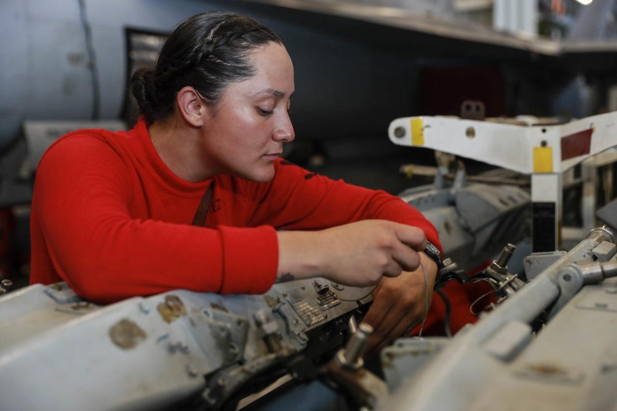 Aviation Ordnanceman 3rd Class Rose Gomez,  a Las Cruces native, recently conducted maintenance on an improved multiple ejection rack (IMER) in the hangar bay aboard USS Abraham Lincoln (CVN 72) on March 17, 2022.