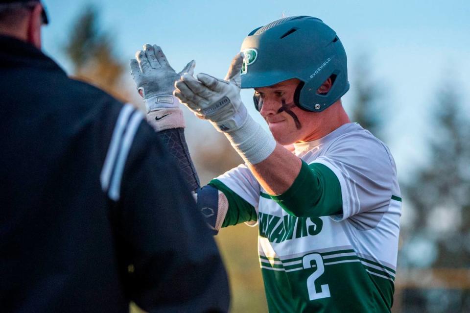 Peninsula’s Payton Knowles celebrates after hitting a single off of Auburn starter Amari Goodfellow in the bottom of the fourth inning of the 3A District 3/4 championship game on Saturday, May 14, 2022, at Auburn High School in Auburn, Wash.