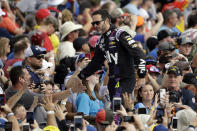 Jimmie Johnson shakes hands with fans during driver introductions before the NASCAR Daytona 500 auto race Sunday, Feb. 16, 2020, at Daytona International Speedway in Daytona Beach, Fla. Johnson is making his last Daytona 500 start. (AP Photo/Chris O'Meara)