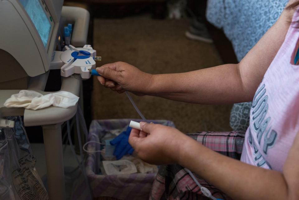 Maria Duenas disinfects her dialysis machine