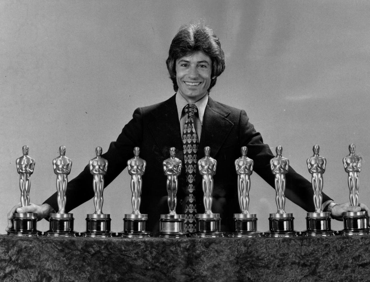 Actor George Chakiris, from Norwood, poses with the 10 Academy Awards given to the 1961 film "West Side Story," including his Oscar for supporting actor.