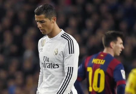 Barcelona's Lionel Messi (R) and Real Madrid's Cristiano Ronaldo react during their Spanish first division "Clasico" soccer match at Camp Nou stadium in Barcelona, March 22, 2015. REUTERS/Paul Hanna