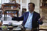 In this Aug. 20, 2019, photo, Huawei's founder Ren Zhengfei gestures as he chats with Huawei executives at the company campus in Shenzhen in Southern China's Guangdong province. Ren says its troubles with President Donald Trump are hardly the biggest crisis he has faced while working his way from rural poverty to the helm of China’s first global tech brand. (AP Photo/Ng Han Guan)