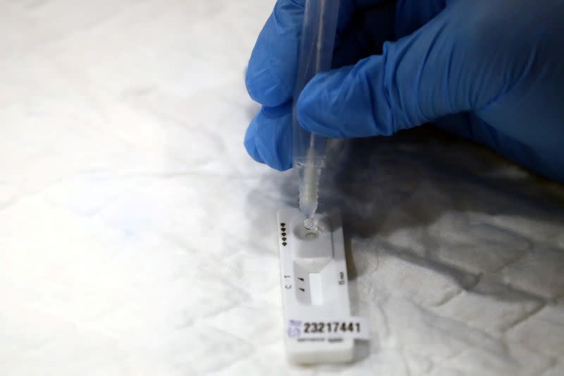FILE PHOTO: A health worker performs a coronavirus disease (COVID-19) antigen test in Madrid
