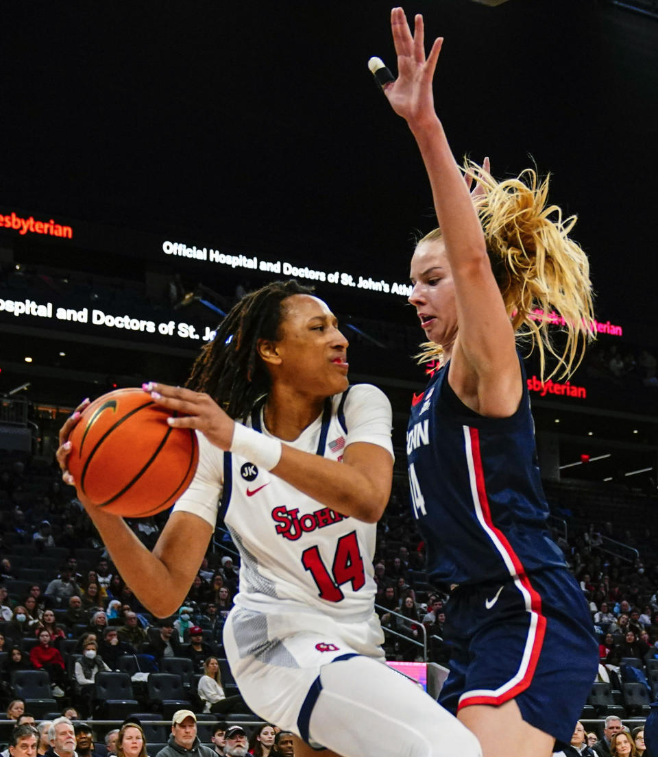 Connecticut's Dorka Juhasz, right, defends St. John's Jillian Archer during the first half of an NCAA basetball game Wednesday, Jan. 11, 2023, in New York. (AP Photo/Frank Franklin II)