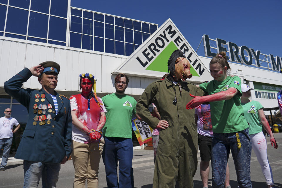 Activists, including Arkadiusz Szczurek, left, take part in a protest outside an outlet of French home improvement retailer Leroy Merlin in Warsaw, Poland, on Saturday May 7, 2022. In the weeks after Russia invaded Ukraine, a protest movement was born in Poland urging people to boycott companies that have chosen to keep operating in Russia. The key target is the home improvement giant Leroy Merlin, a popular French retailer. Protests have been held across Poland over the company's decision to keep operating its 112 stores in Russia even as many other Western companies have suspended operations there. (AP Photo/Pawel Kuczynski)