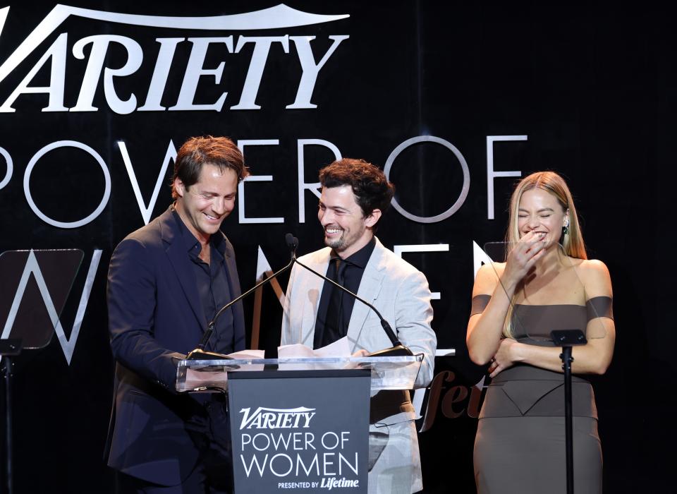 LOS ANGELES, CALIFORNIA - NOVEMBER 16: (L-R) Honorees Tom Ackerley, Josey McNamara, and Margot Robbie speak onstage during Variety Power of Women Los Angeles presented by Lifetime at Mother Wolf on November 16, 2023 in Los Angeles, California. (Photo by Amy Sussman/Variety via Getty Images)