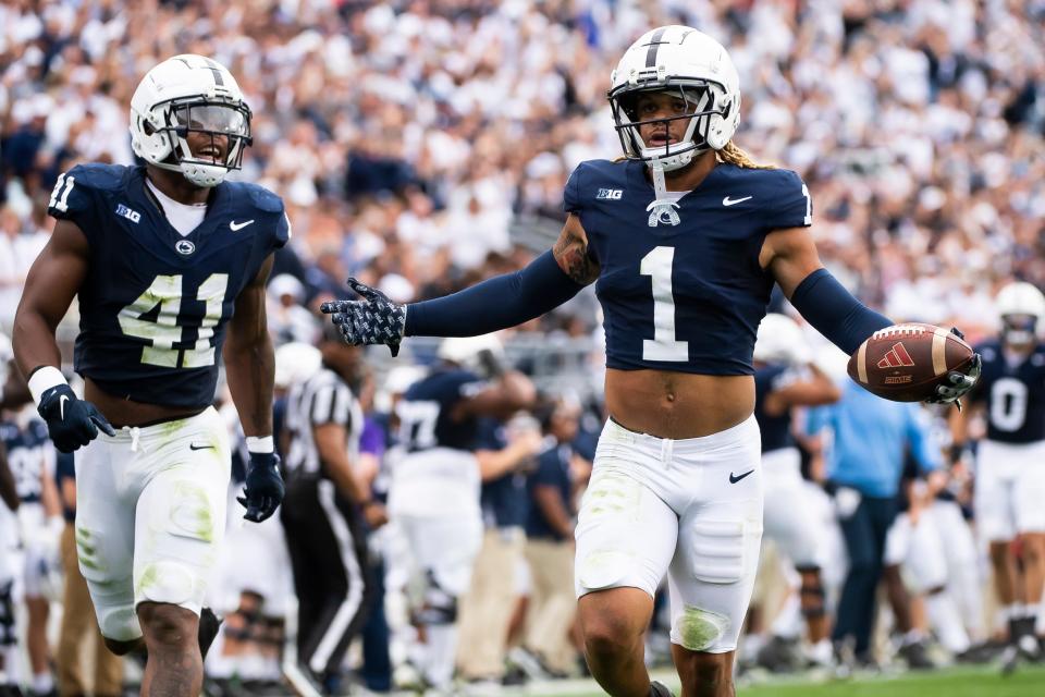 Penn State safety Jaylen Reed (1) reacts after intercepting a pass and returning it 17 yards in the first half of an NCAA football game against Indiana Saturday, Oct. 28, 2023, in State College, Pa. The Nittany Lions won, 33-24.