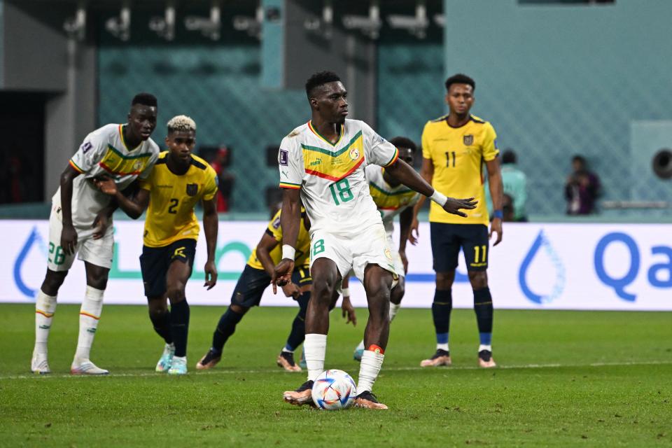 TOPSHOT - Senegal's forward #18 Ismaila Sarr (C) scores his team's first goal from the penalty spot during the Qatar 2022 World Cup Group A football match between Ecuador and Senegal at the Khalifa International Stadium in Doha on November 29, 2022. (Photo by OZAN KOSE / AFP) (Photo by OZAN KOSE/AFP via Getty Images)