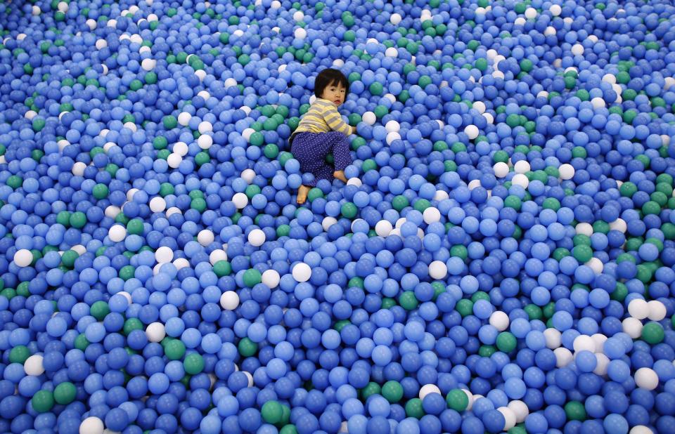 Two-year-old Nao Watanabe plays in a ball pit at an indoor playground which was built for children and parents who refrain from playing outside because of concerns about nuclear radiation in Koriyama, west of the tsunami-crippled Fukushima Daiichi nuclear power plant, Fukushima prefecture February 27, 2014. (REUTERS/Toru Hanai)