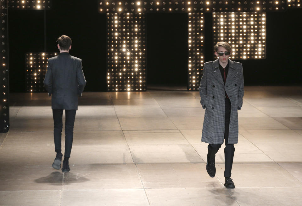 Models present creations as part of French born fashion designer Hedi Slimane for Saint Laurent men's Fall-Winter 2014-2015 fashion collection, presented Sunday, Jan. 19, 2014 in Paris. (AP Photo/Christophe Ena)