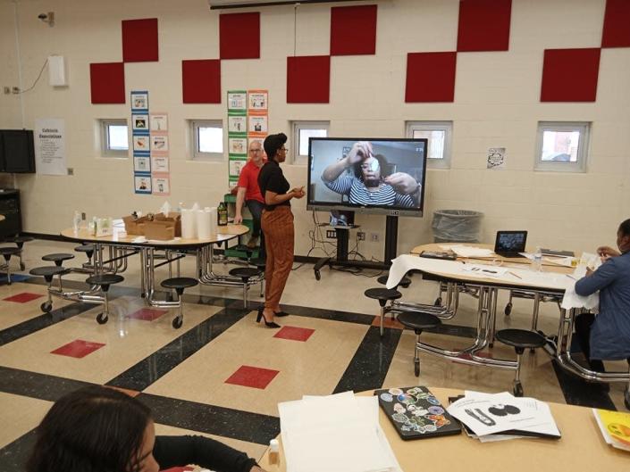 Dr. Rasheda Likely leads the &quot;Lotions and Potions&quot; session with Grant Middle School girls.