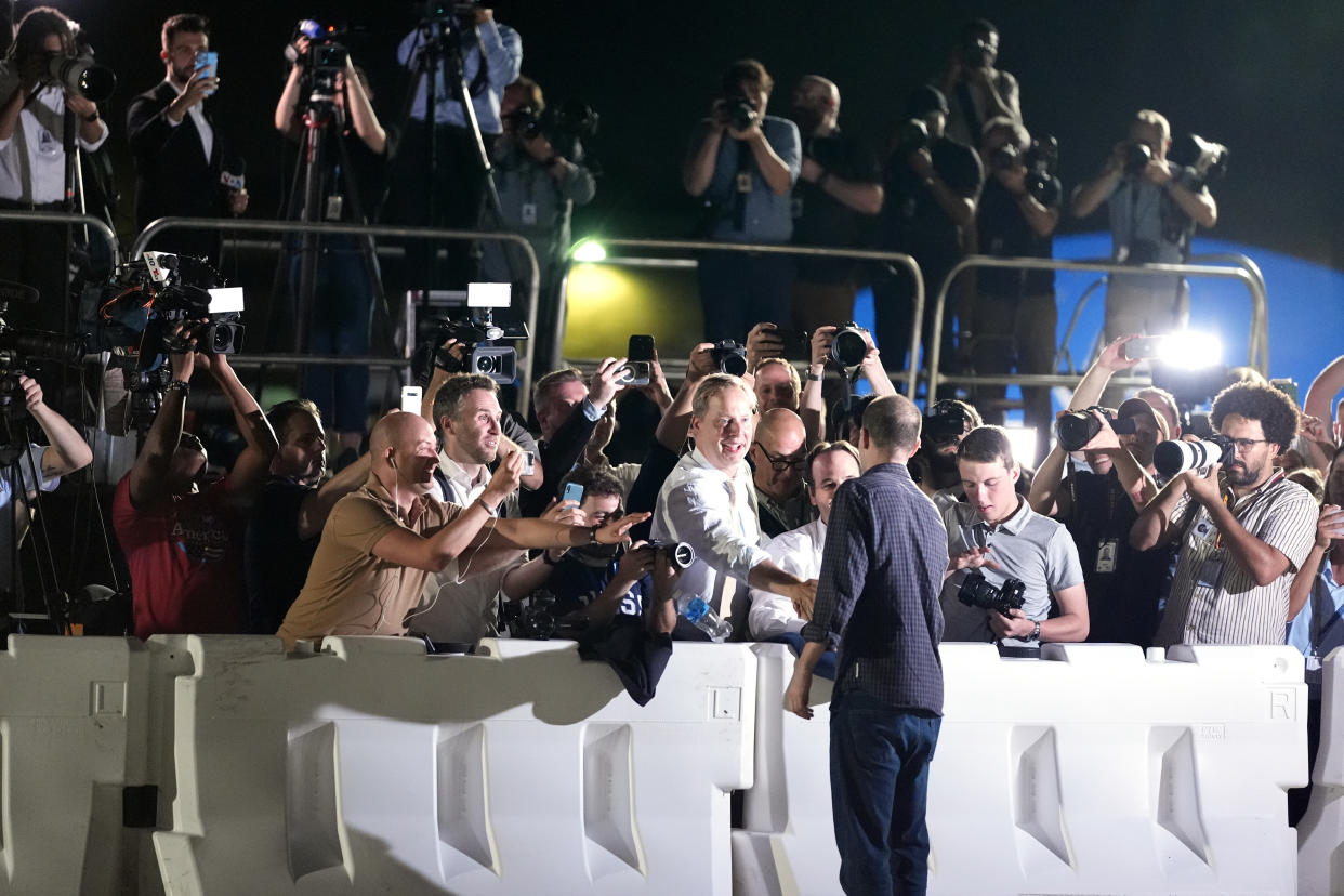 Reporter Evan Gershkovich greets colleagues at Andrews Air Force Base, Md., following his release as part of a 24-person prisoner swap between Russia and the United States on Aug. 1.