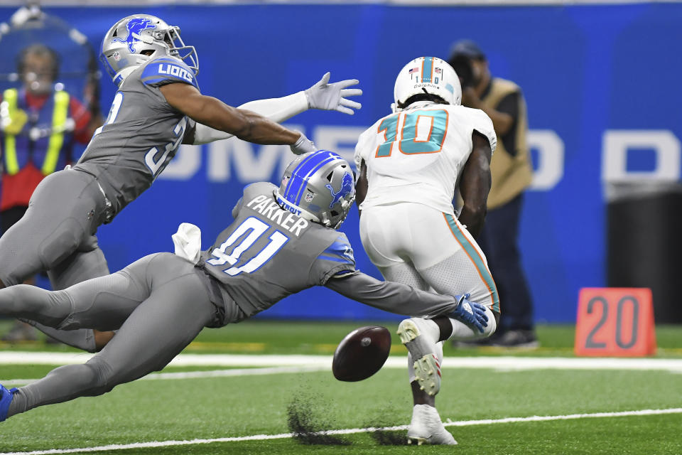 Miami Dolphins wide receiver Tyreek Hill (10), defended by Detroit Lions cornerback AJ Parker (41) and safety JuJu Hughes, drops a pass during the first half of an NFL football game, Sunday, Oct. 30, 2022, in Detroit. (AP Photo/Lon Horwedel)