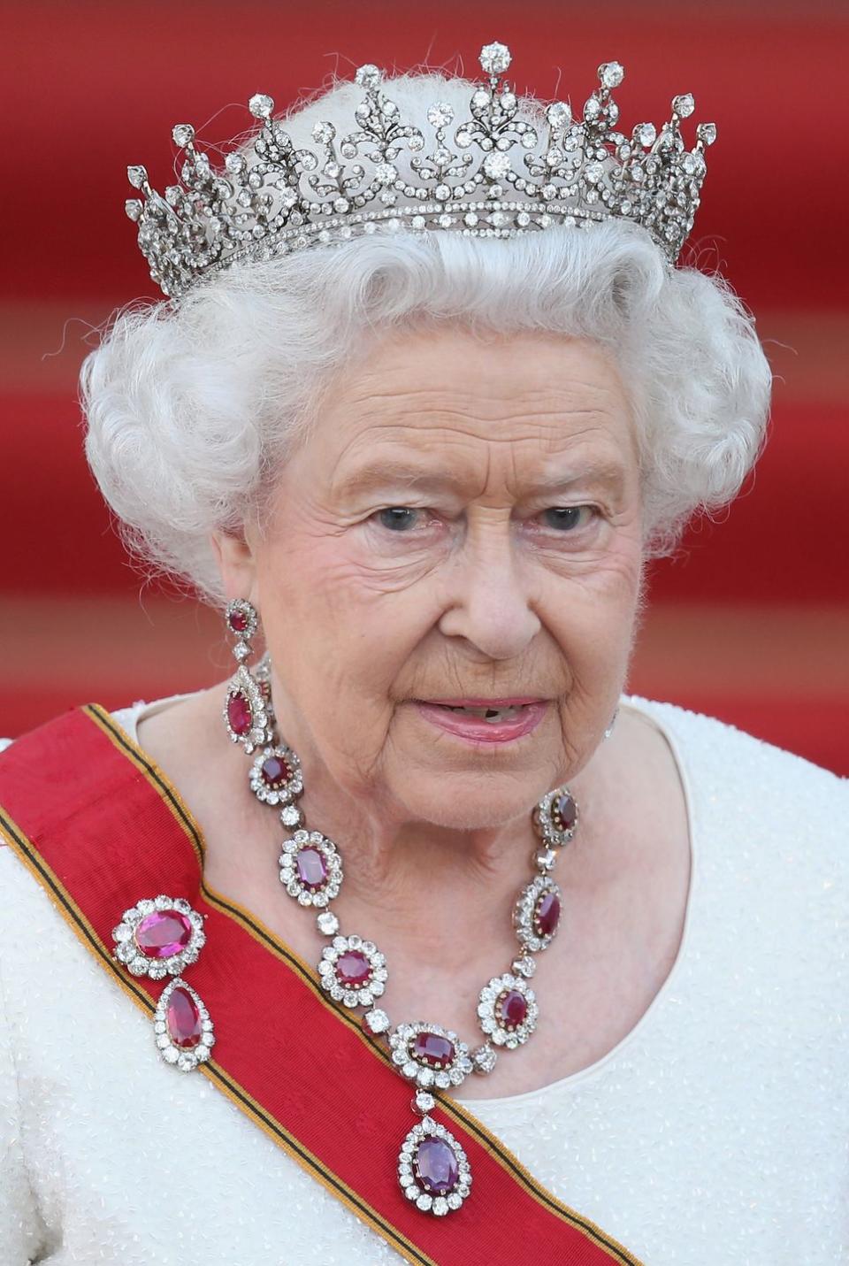 <p>Queen Elizabeth II wore an oversized and elegant ruby and diamond necklace and matching brooch—paired with a quiet ivory dress—to a state banquet at Schloss Bellevue palace. </p>