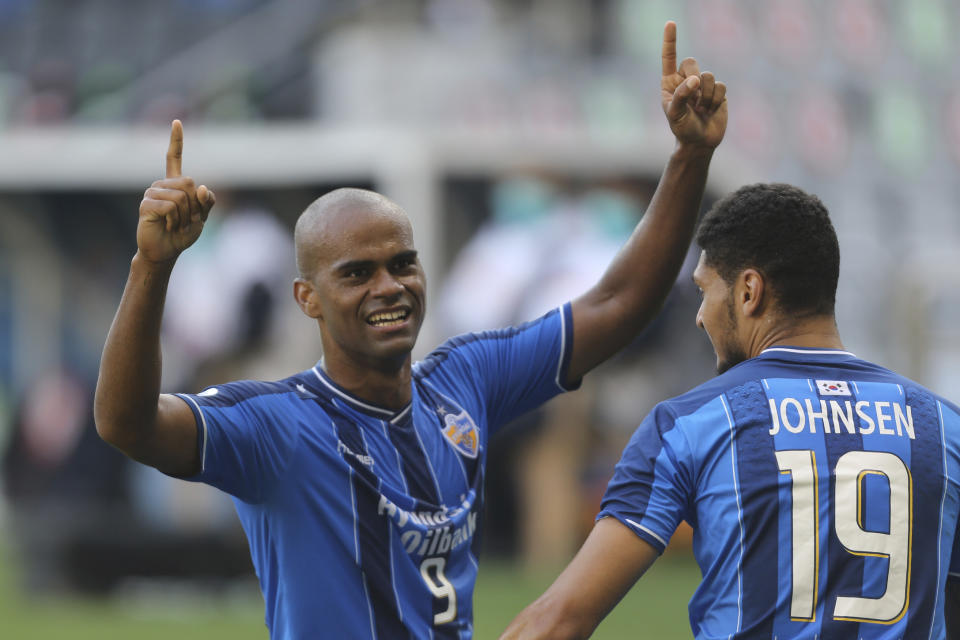 Ulsan Hyundai's Júnior Negrão, left, celebrates after scoring his side's second goal from penalty spot during the Champions League semifinal soccer match between Vissel Kobe and Ulsan Hyundai FC at Jassim Bin Hamad Stadium in Doha, Qatar, Sunday, Dec. 13, 2020. (AP Photo/Hussein Sayed)