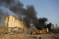 Black smoke rises from the explosion scene that hit the seaport of Beirut, Lebanon, Tuesday, Aug. 4, 2020. Massive explosions rocked downtown Beirut on Tuesday, flattening much of the port, damaging buildings and blowing out windows and doors as a giant mushroom cloud rose above the capital. Witnesses saw many people injured by flying glass and debris. (AP Photo/Hussein Malla)