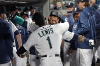 Seattle Mariners' Jacob Nottingham is congratulated on his solo home run against the Texas Rangers in the third inning of a baseball game, Thursday, May 27, 2021, in Seattle. (AP Photo/Elaine Thompson)