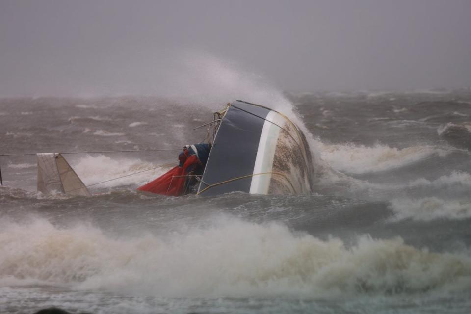 <p>A capsized boat washes ashore as Hurricane Helene churns offshore on September 26, 2024 in St. Peteersburg Florida</p> (Getty Images)