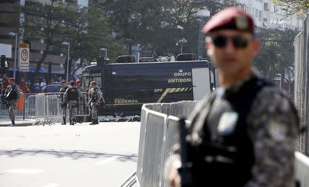 Bomb squad agents control the area near the finishing line of the men's cycling road race at the 2016 Rio Olympics after they made a controlled explosion, in Copacabana, Rio de Janeiro, Brazil August 6, 2016. REUTERS/Eric Gaillard