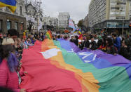 FILE - People take part in the annual Gay Pride parade, under the protection of riot police in Kyiv, Ukraine, Sunday, Sept. 19, 2021. Despite the war in Ukraine, the country's largest LGBT rights event, KyivPride, is going ahead on Saturday, June 25, 2022. But not on its native streets and not as a celebration of gay pride. It will instead join Warsaw's yearly Equality Parade, using it as a platform to keep international attention focused on the Ukrainian struggle for freedom. (AP Photo/Efrem Lukatsky, File)