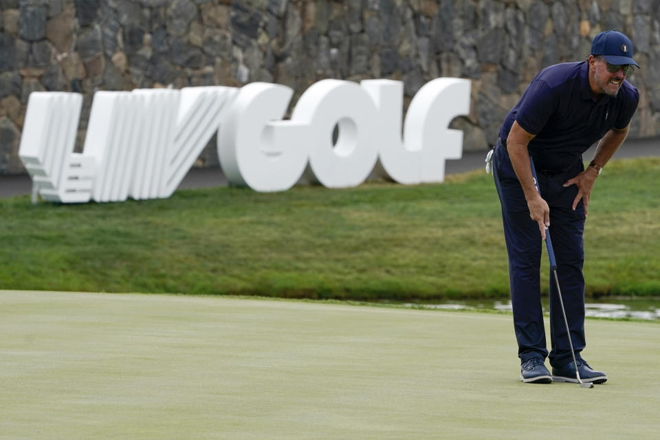 Phil Mickelson lines up a shot on the 18th hole during the first round of the Bedminster Invitational LIV Golf tournament in Bedminster, N.J., Friday, July 29, 2022. (AP Photo/Seth Wenig)