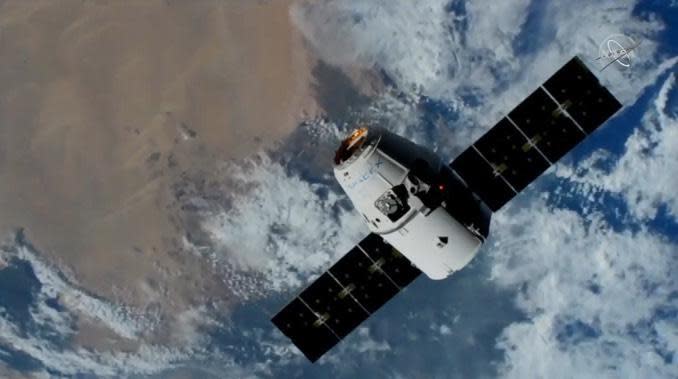 A SpaceX Dragon capsule, carrying cargo, sails above northern Africa during its final approach to the International Space Station. / Credit: NASA