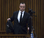 Oscar Pistorius arrives at a courtroom for his ongoing murder trial at the high court in Pretoria, South Africa, Tuesday, May 13, 2014. Pistorius is charged with the shooting death of his girlfriend Reeva Steenkamp on Valentine's Day in 2013. (AP Photo/Daniel Born, Pool)