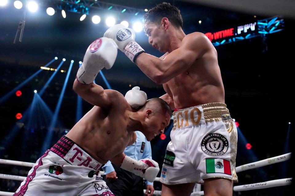 Isaac Cruz, left, and Giovanni Cabrera fight during their lightweight boxing match (AP)