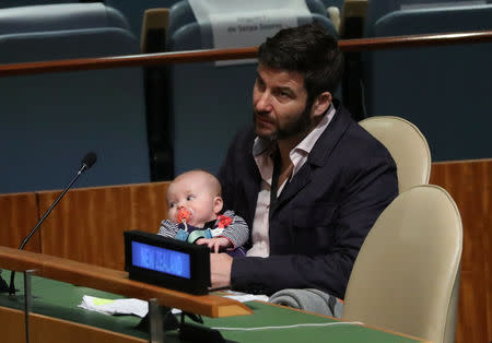 Clarke Gayford, partner to New Zealand Prime Minister Jacinda Ardern holds their baby Neve as Ardern speaks at the Nelson Mandela Peace Summit during the 73rd United Nations General Assembly in New York, U.S., September 24, 2018. REUTERS/Carlo Allegri