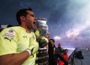 Chile's goalie Claudio Bravo holds onto the trophy after defeating Argentina to win the Copa America 2015 final soccer match at the National Stadium in Santiago, Chile, July 4, 2015. REUTERS/Marcos Brindicci