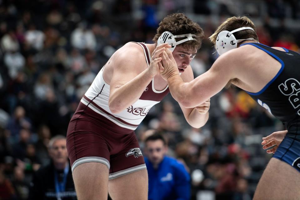 Wellington's Tanner Gray battles Resurrection Christian's Will Reeves during his match at the Colorado state wrestling tournament at Ball Arena in Denver on Saturday.