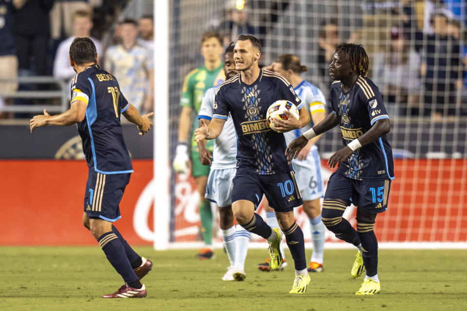 Philadelphia Union's Daniel Gazdag, center, celebrates after his penalty kick for a goal with Alejandro Bedoya, left, and Olivier Mbaizo, right, during the second half of an MLS soccer match against CF Montreal, Saturday, June 1, 2024, in Chester, Pa. (AP Photo/Chris Szagola)