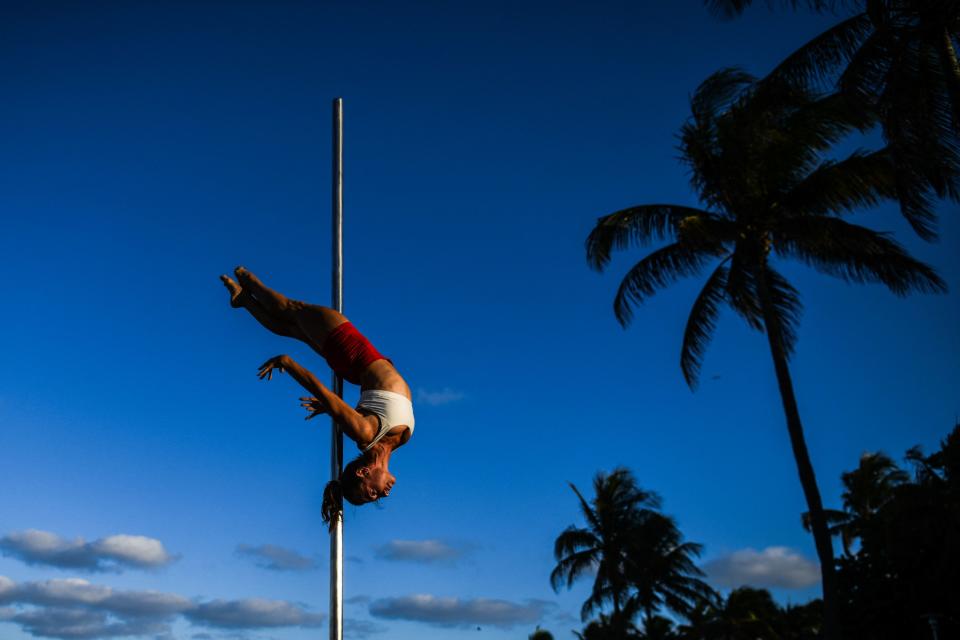 Nataliya Nomada practices pole acrobatics on the beach in Miami Beach, Florida on April 26, 2022. (Photo by CHANDAN KHANNA / AFP) (Photo by CHANDAN KHANNA/AFP via Getty Images)