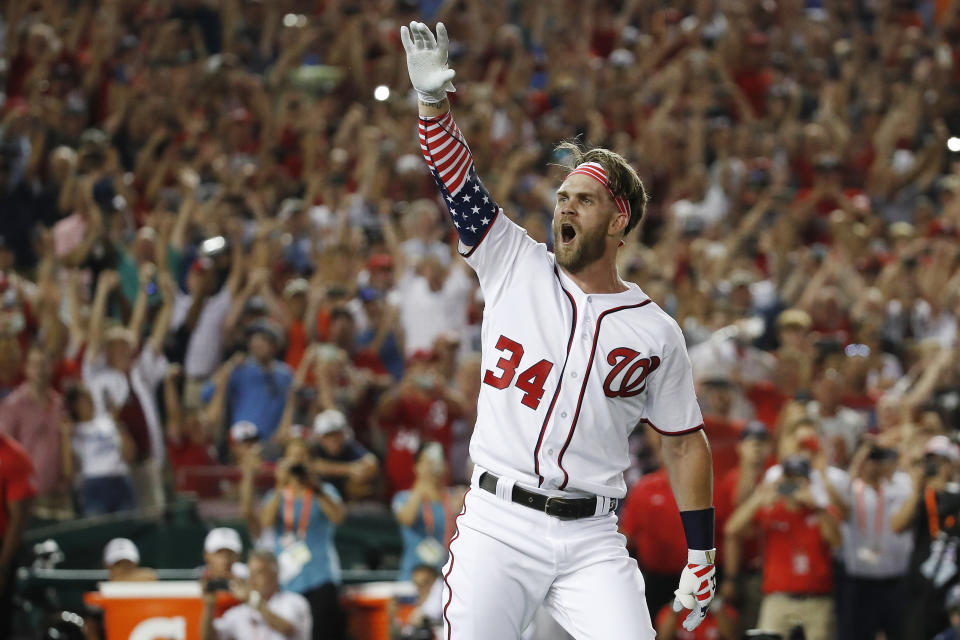 FILE - In this July 16, 2018, file photo, Washington Nationals Bryce Harper (34) reacts to his winning hit during the Major League Baseball Home Run Derby, in Washington. A person familiar with the negotiations tells The Associated Press that Bryce Harper and the Philadelphia Phillies have agreed to a $330 million, 13-year contract, the largest deal in baseball history. The person spoke to the AP on condition of anonymity Thursday, Feb. 28, 2019, because the agreement is subject to a successful physical. (AP Photo/Alex Brandon, File)