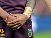 A Brisbane Broncos player wears a 'Rise for Alex' wristband.