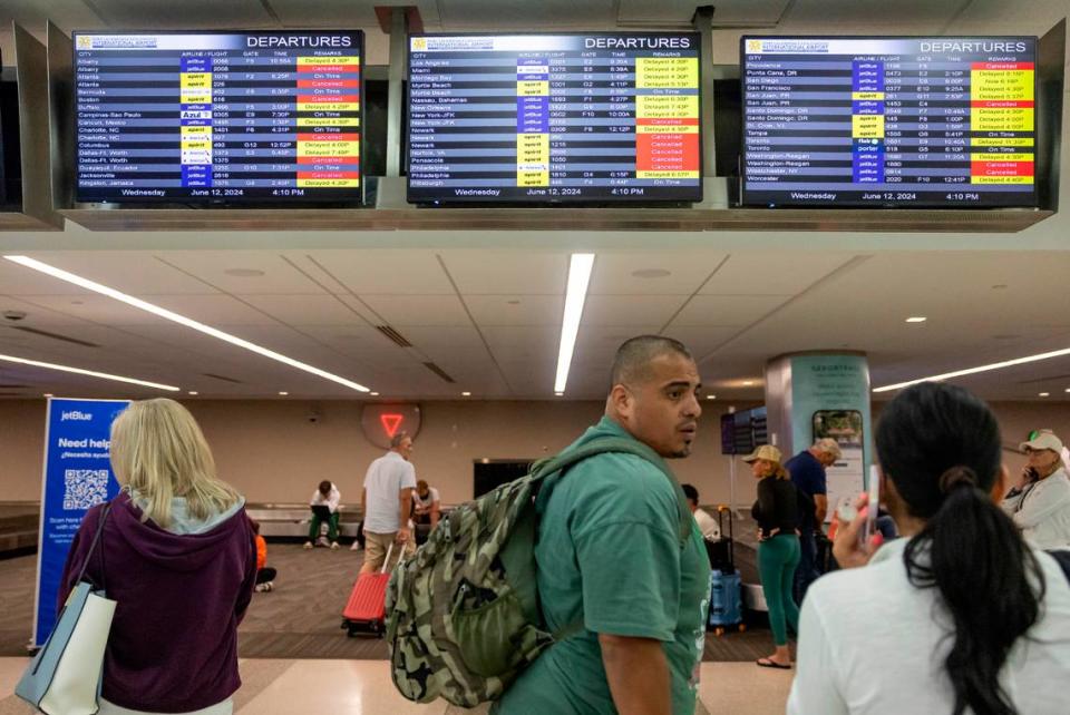 James Rodriguez talks with his wife, Diana, after their flight to Cancun was canceled at the Fort Lauderdale-Hollywood International Airport due to heavy downpours across South Florida on Wednesday, June 12, 2024 in Fort Lauderdale, Fla.